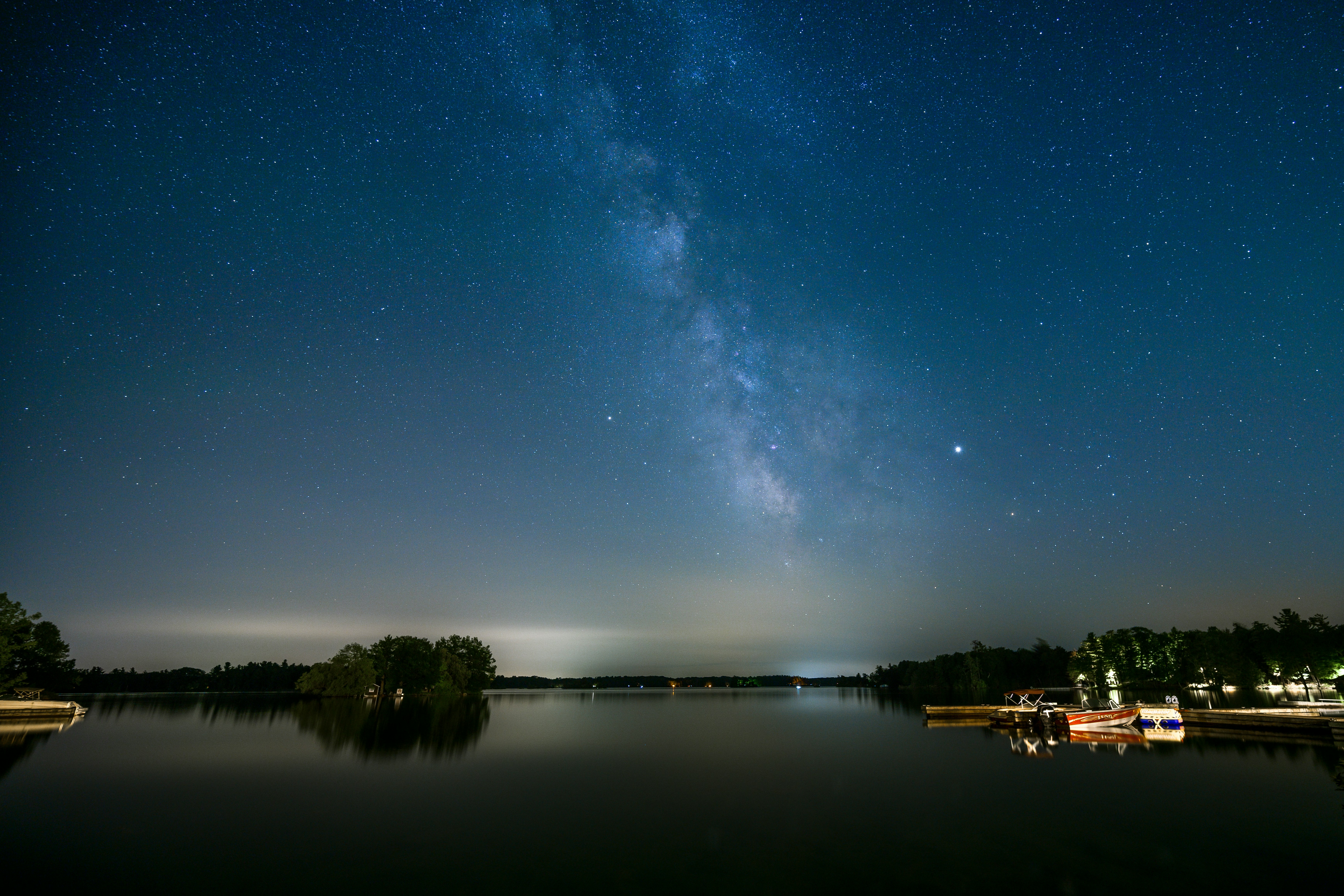 body of water near trees during night time